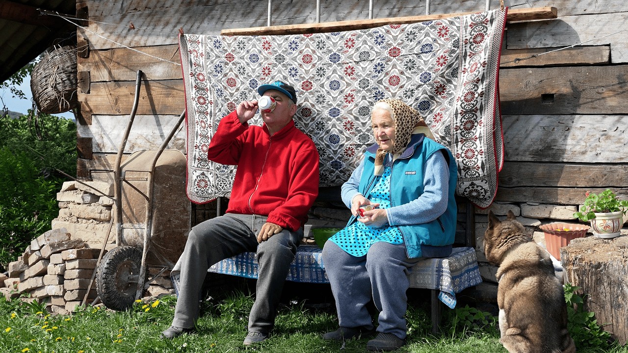 Grandmother and son drinking tea with the dog